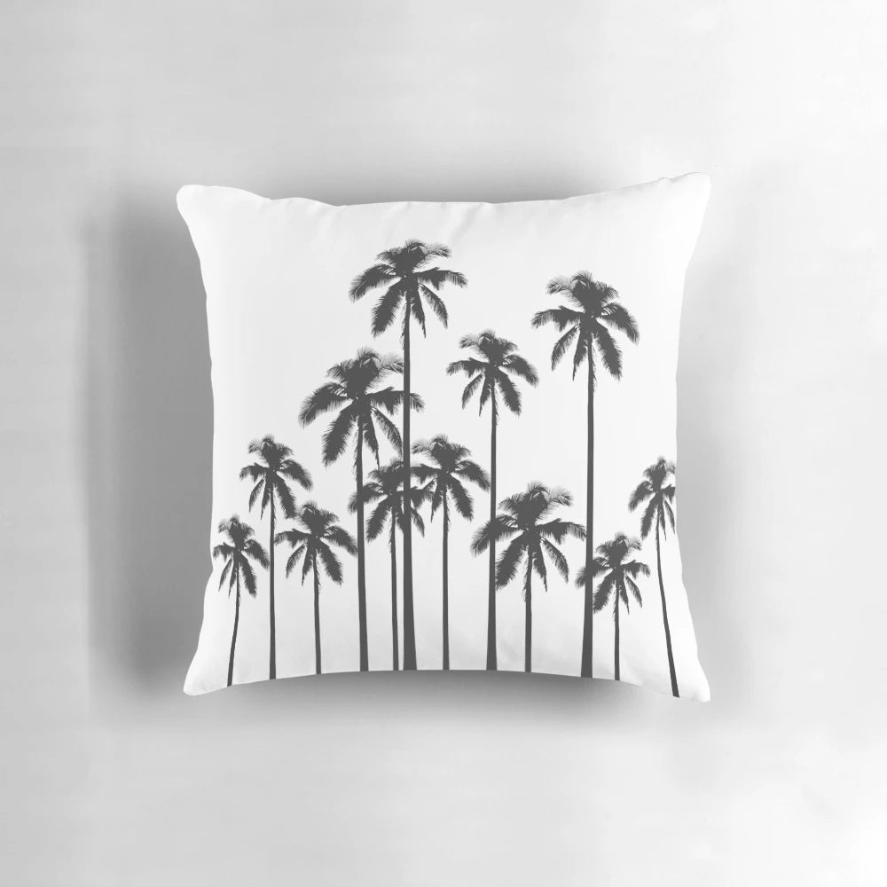 A stylish black and white throw pillow featuring a tropical palm tree pattern.