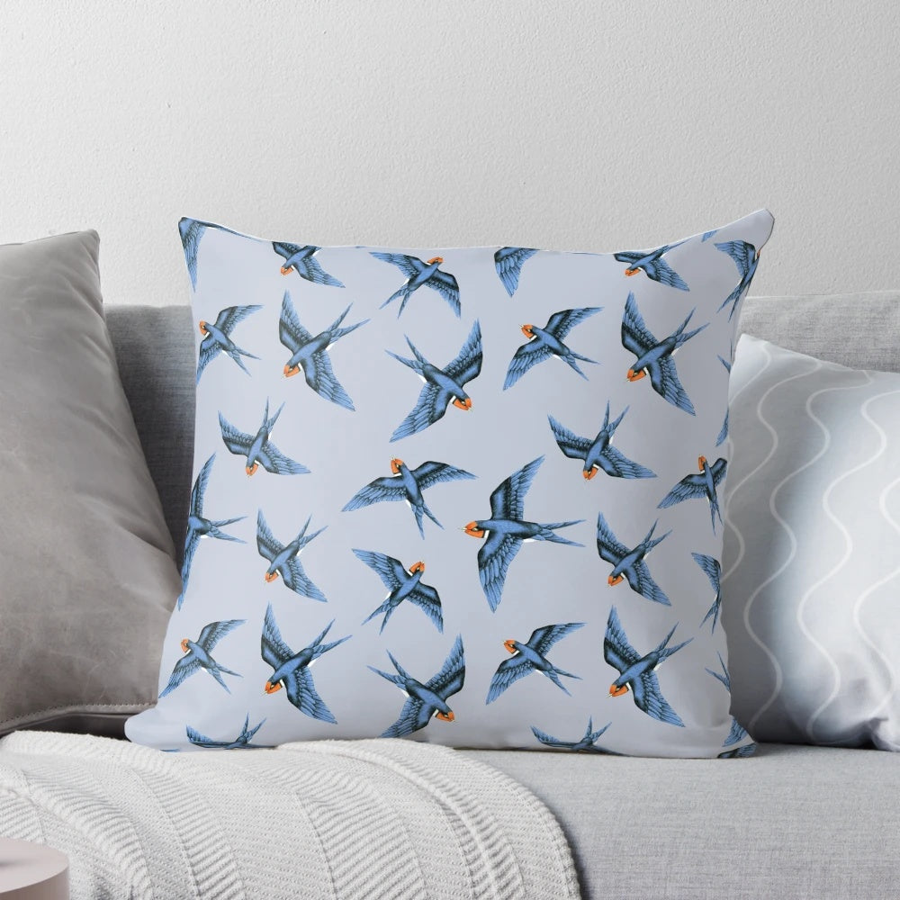 Decorative pillow featuring a blue swallow bird in flight on a stormy grey background