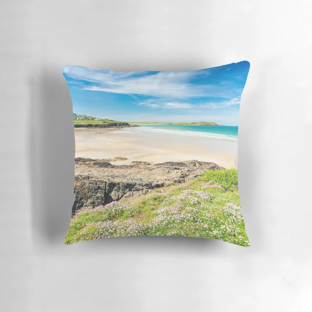 Vibrant wildflowers overlooking the picturesque Polzeath beach in Cornwall, England