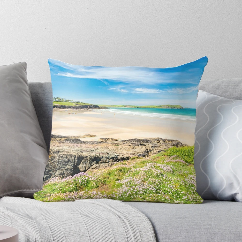 Vibrant wildflowers overlooking the picturesque Polzeath beach in Cornwall, England