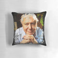 A decorative throw pillow featuring a watercolor portrait of the renowned naturalist David Attenborough