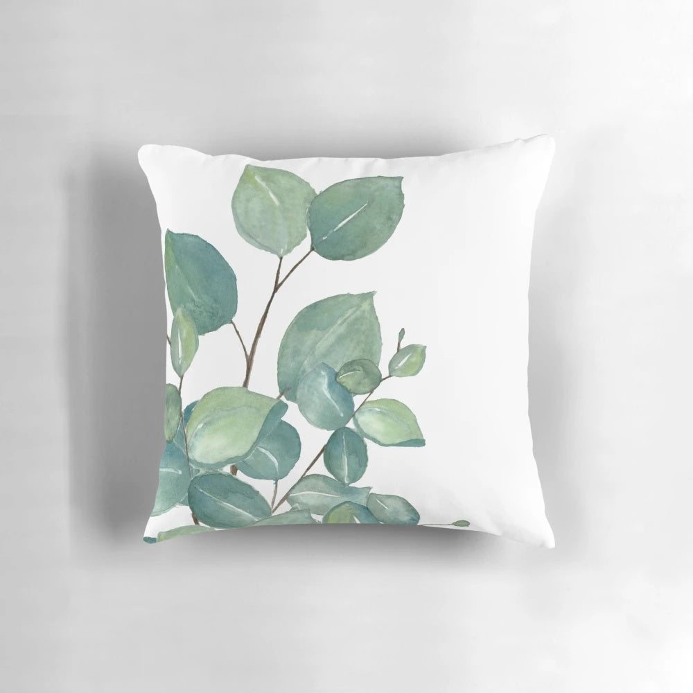 Vibrant watercolor painting of eucalyptus leaves on a soft, plush pillow.