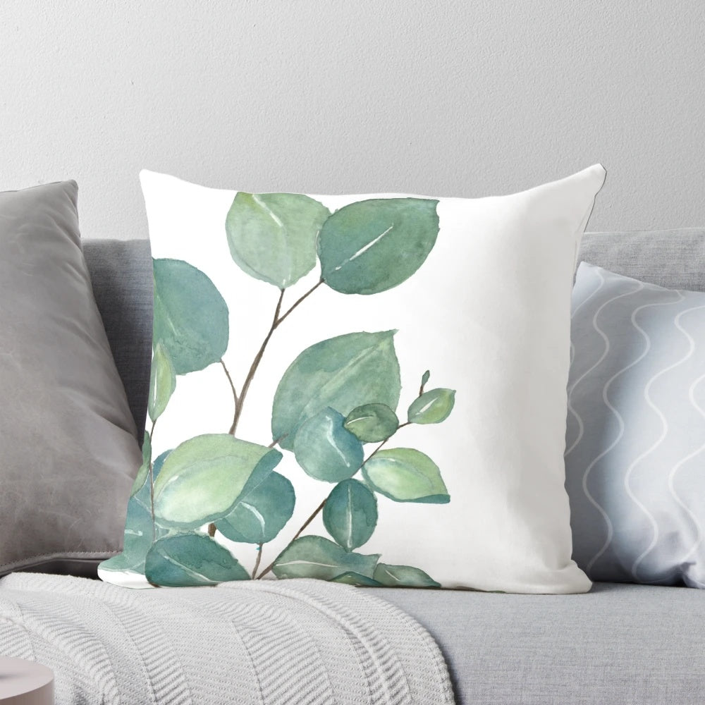 Vibrant watercolor painting of eucalyptus leaves on a soft, plush pillow.