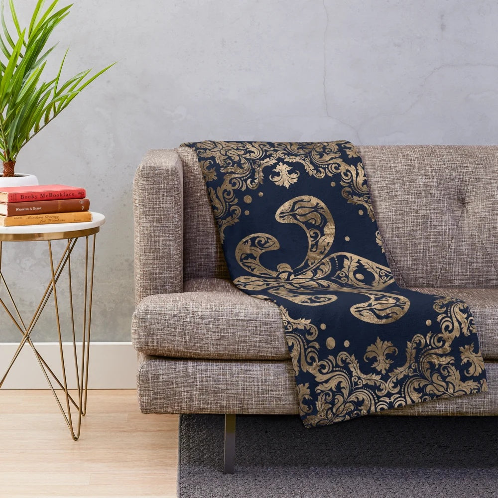 Fleur-de-lis inspired plush blanket with golden and dark blue accents