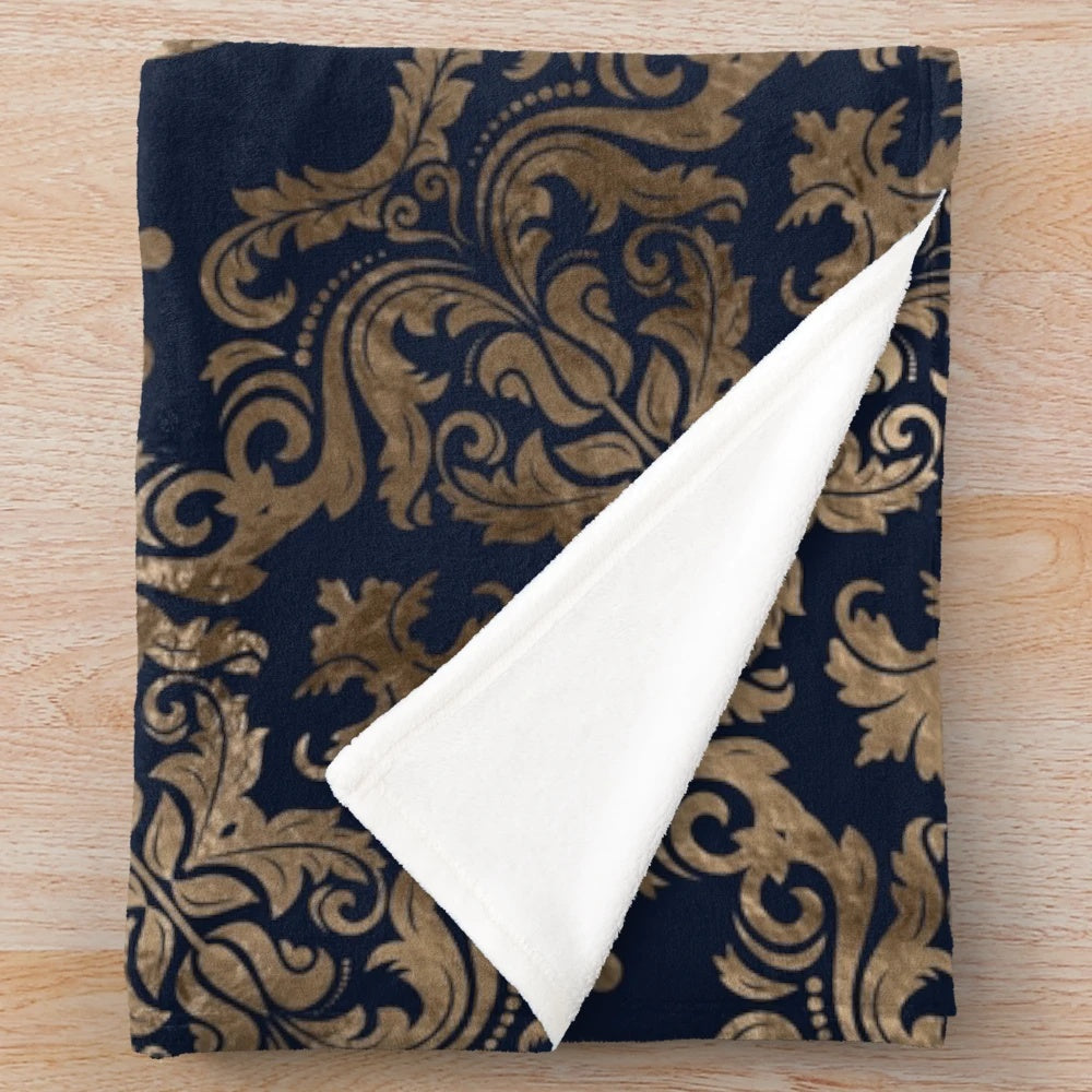 Fleur-de-lis inspired plush blanket with golden and dark blue accents