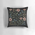 Decorative pillow with a vibrant floral design in a dark, nighttime palette.