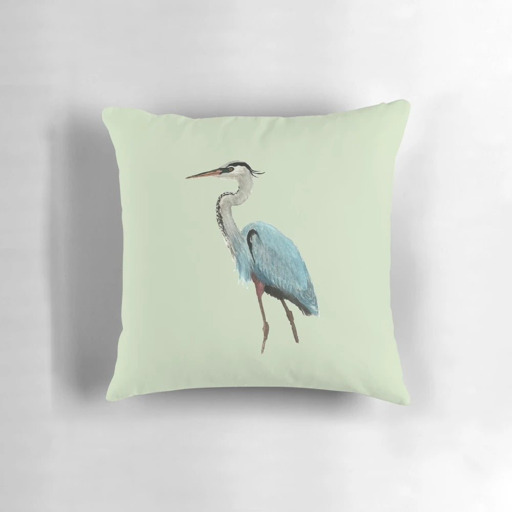 Vibrant blue and gray great blue heron bird on a decorative pillow