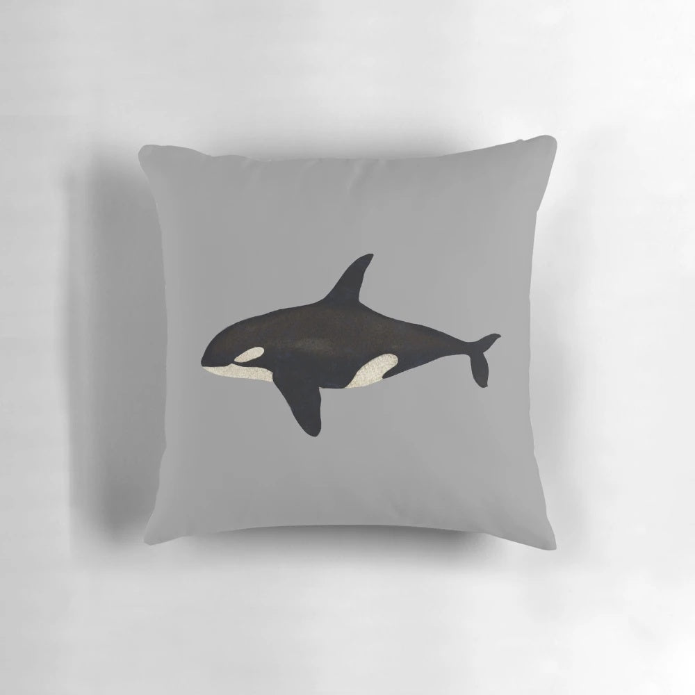 Vibrant watercolor illustration of a killer whale or orca on a soft, plush pillow