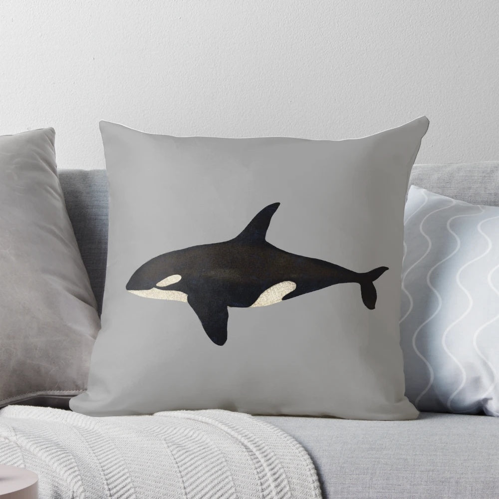 Vibrant watercolor illustration of a killer whale or orca on a soft, plush pillow