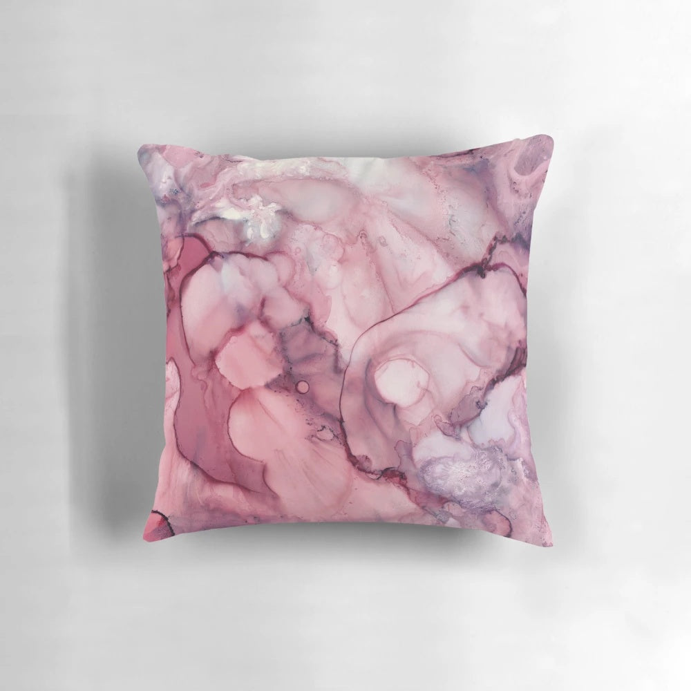 Vibrant and abstract liquid mauve colored pillow with a modern, artistic design.