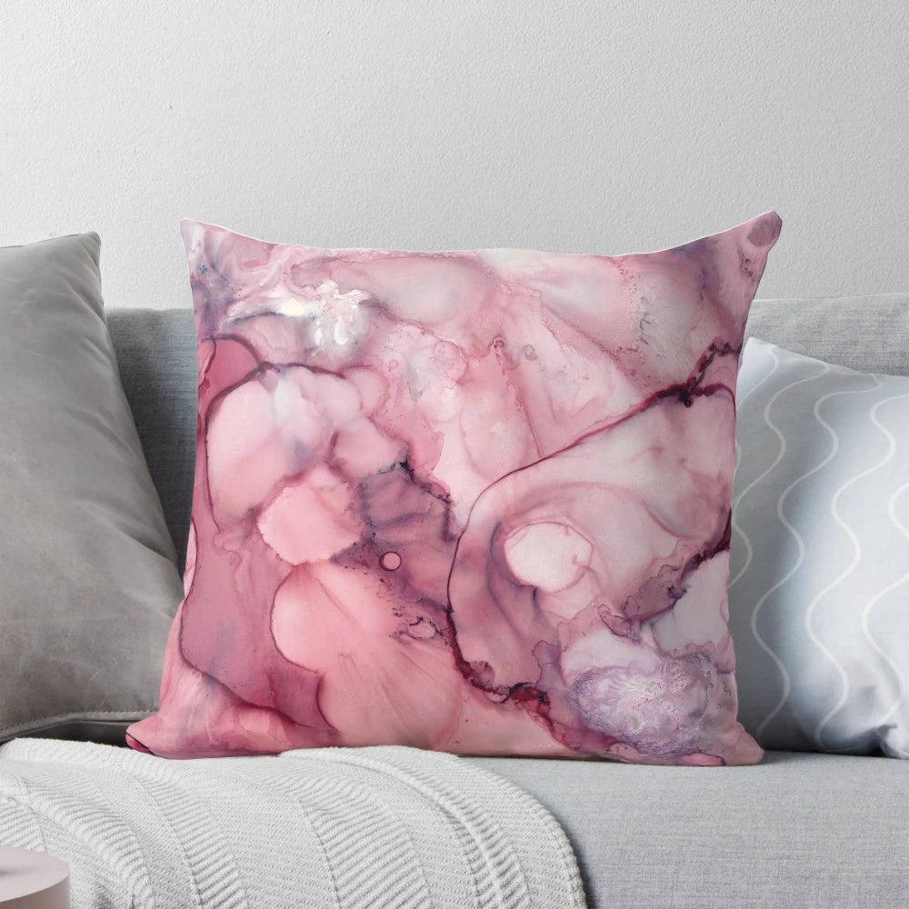 Vibrant and abstract liquid mauve colored pillow with a modern, artistic design.