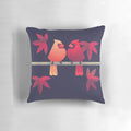 A beautiful pillow featuring a pair of vibrant northern cardinals perched on a Japanese maple tree.