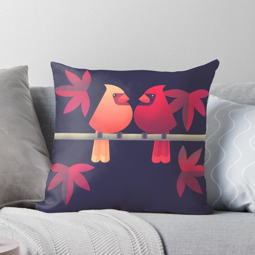 A beautiful pillow featuring a pair of vibrant northern cardinals perched on a Japanese maple tree.