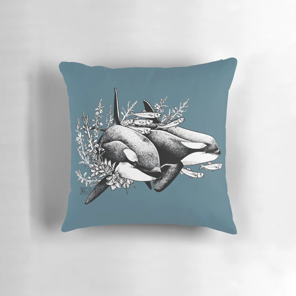A throw pillow featuring a detailed ink drawing of orcas or killer whales swimming in the ocean with a floral pattern.