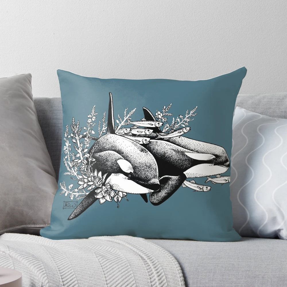 A throw pillow featuring a detailed ink drawing of orcas or killer whales swimming in the ocean with a floral pattern.