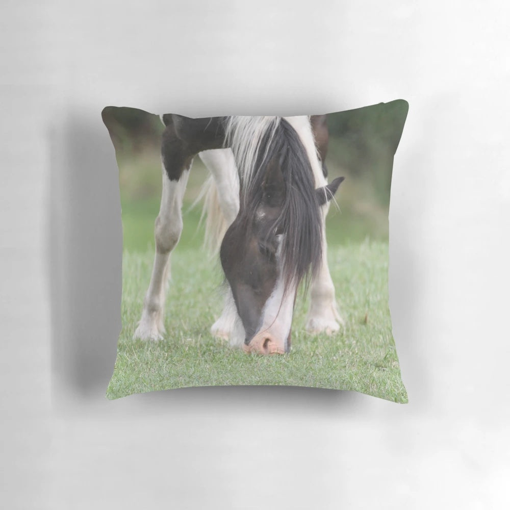 A vibrant, artistic painting of a horse on a plush, decorative pillow.