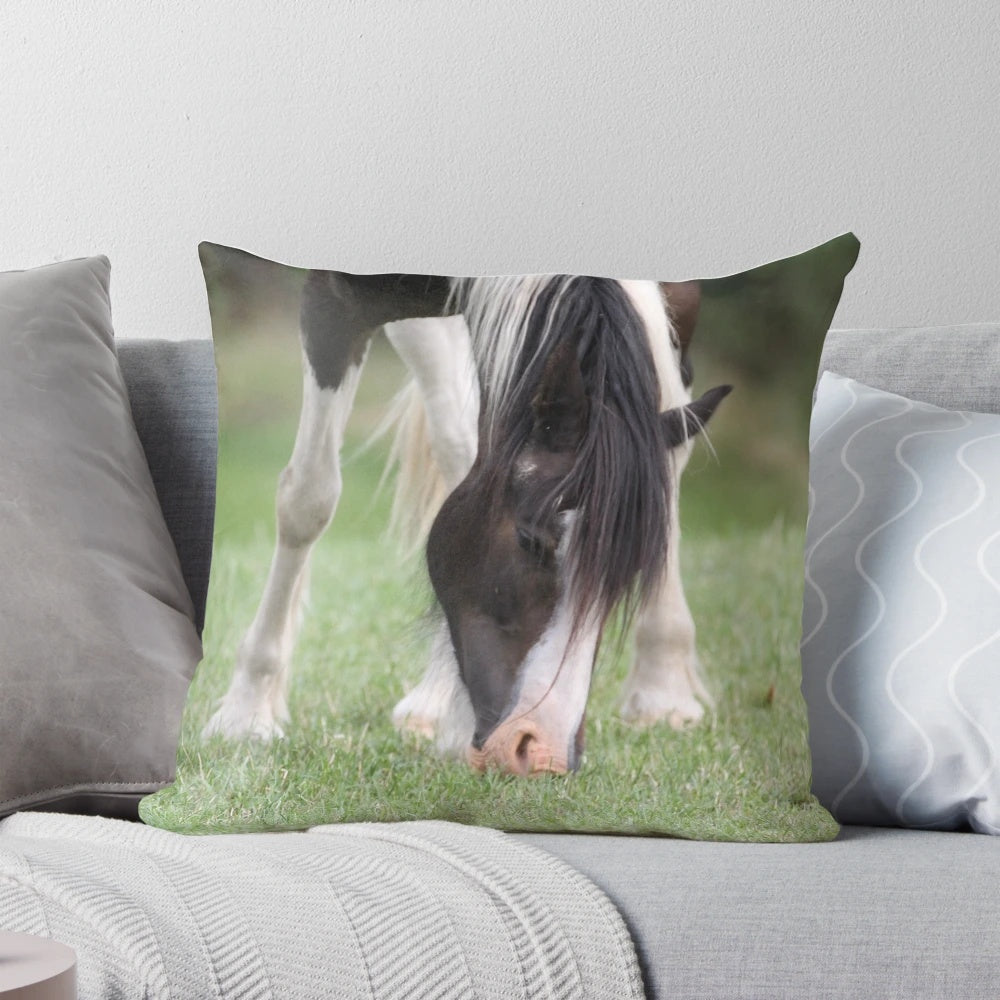 A vibrant, artistic painting of a horse on a plush, decorative pillow.