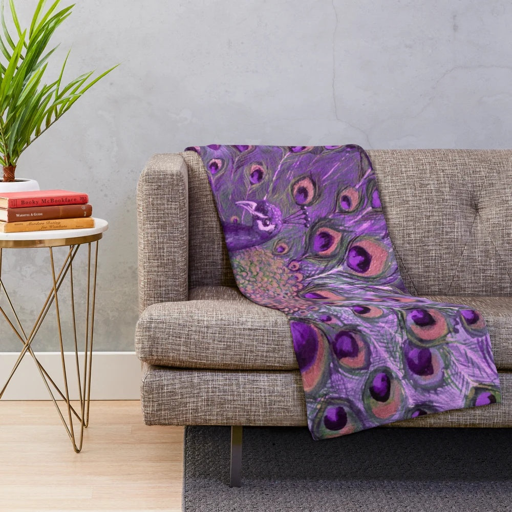 Vibrant purple and gold peacock plush blanket with iridescent feather design