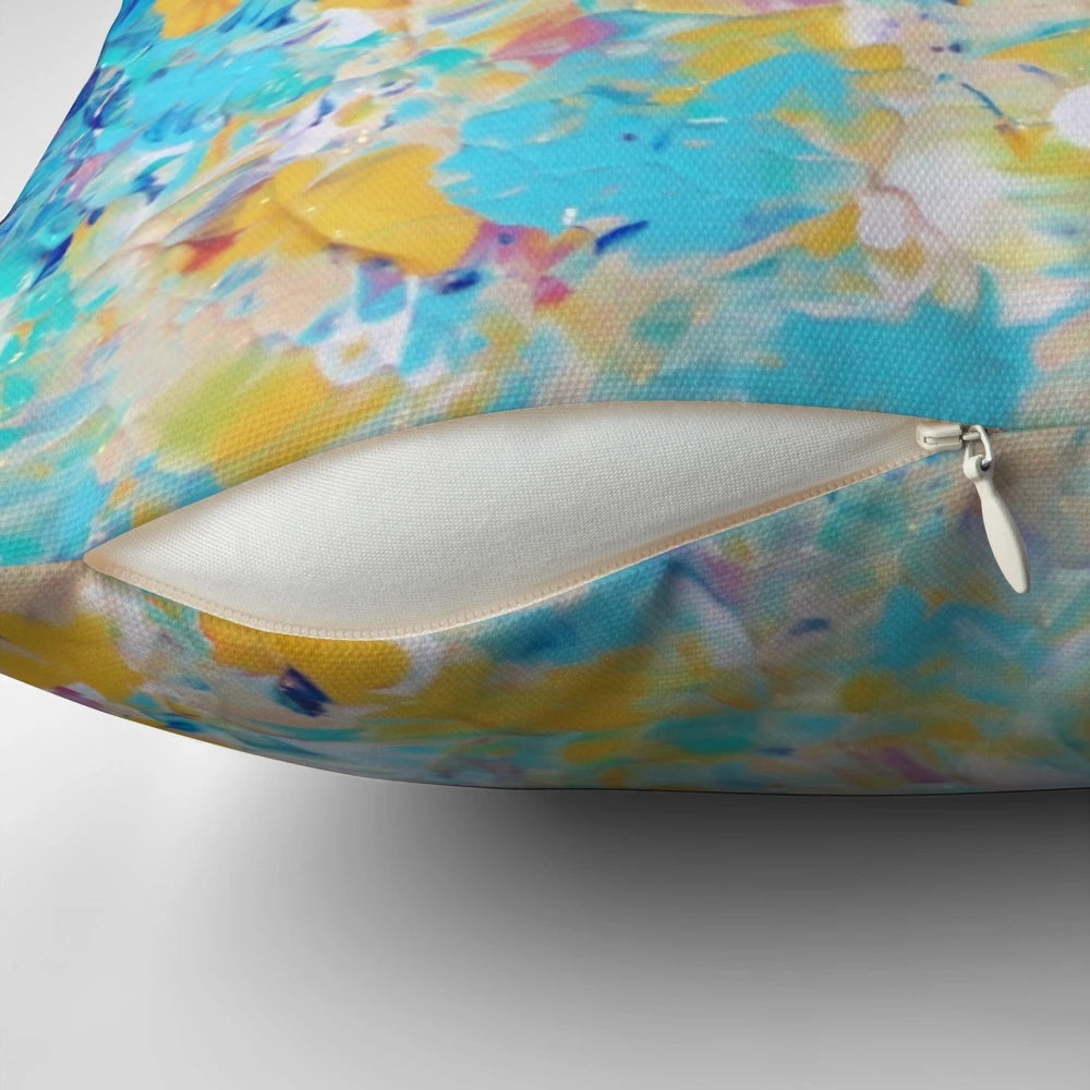 A vibrant, abstract nature-inspired pillow in shades of royal blue, navy, and turquoise.