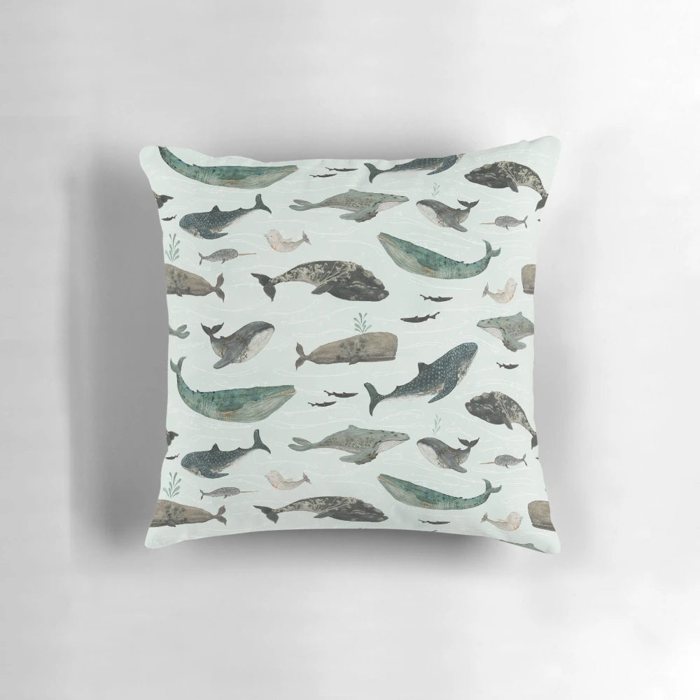 Vibrant tattooed whales printed on a plush throw pillow, perfect for adding a touch of ocean-inspired style to your home.