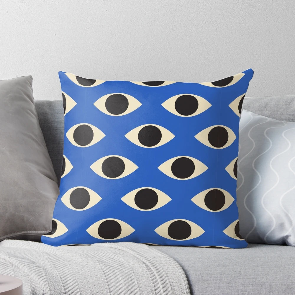 A vibrant blue and white patterned pillow featuring the iconic Turkish Evil Eye design, perfect for adding a touch of bohemian style to any room.