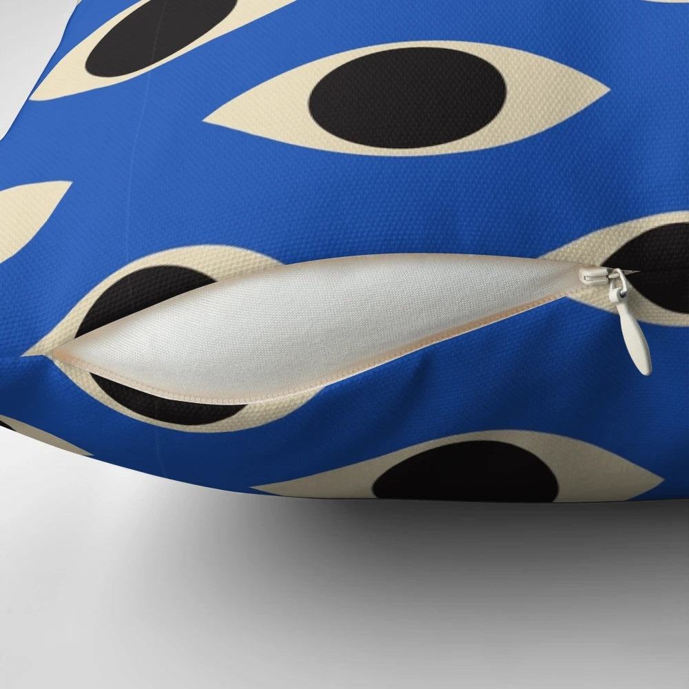 A vibrant blue and white patterned pillow featuring the iconic Turkish Evil Eye design, perfect for adding a touch of bohemian style to any room.