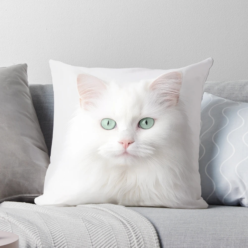 Soft, fluffy white Persian cat with vibrant green eyes on a decorative pillow