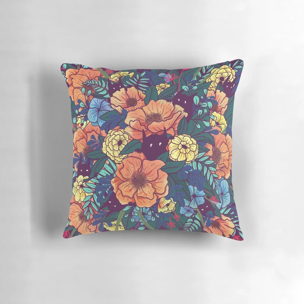A vibrant, watercolor-style pillow featuring a bouquet of wild flowers in shades of pink, purple, and green.