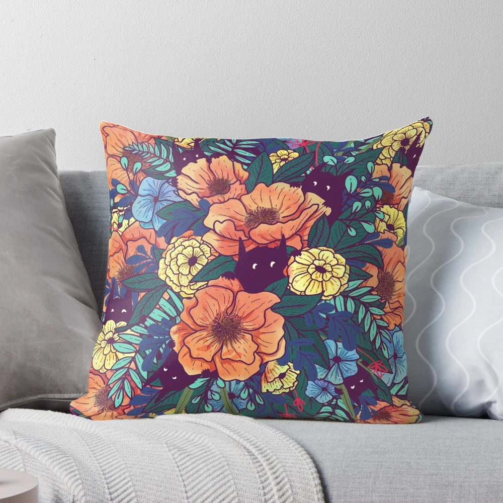 A vibrant, watercolor-style pillow featuring a bouquet of wild flowers in shades of pink, purple, and green.