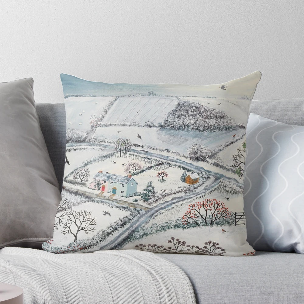A cozy pillow featuring a winter landscape with snowy hills, houses, and birds in the snow.