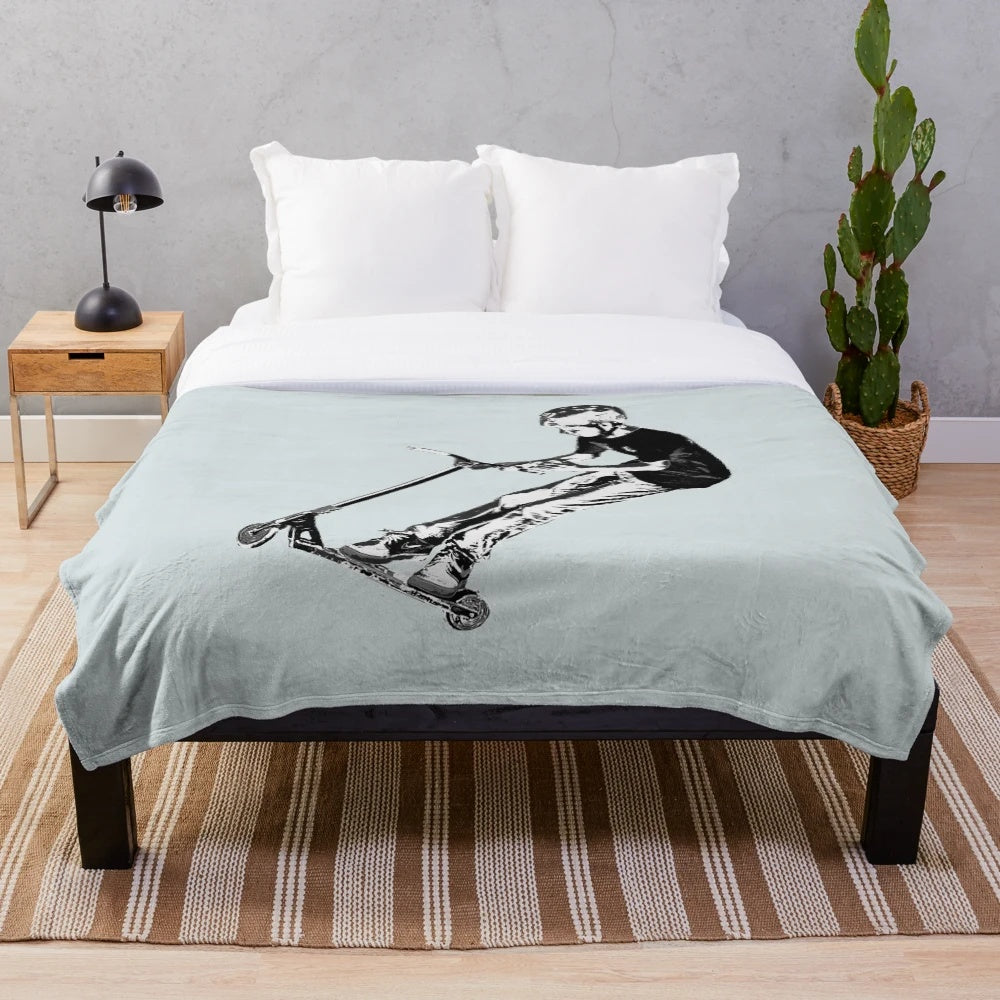 Plush blanket featuring a scooter performing a mid-air turn stunt