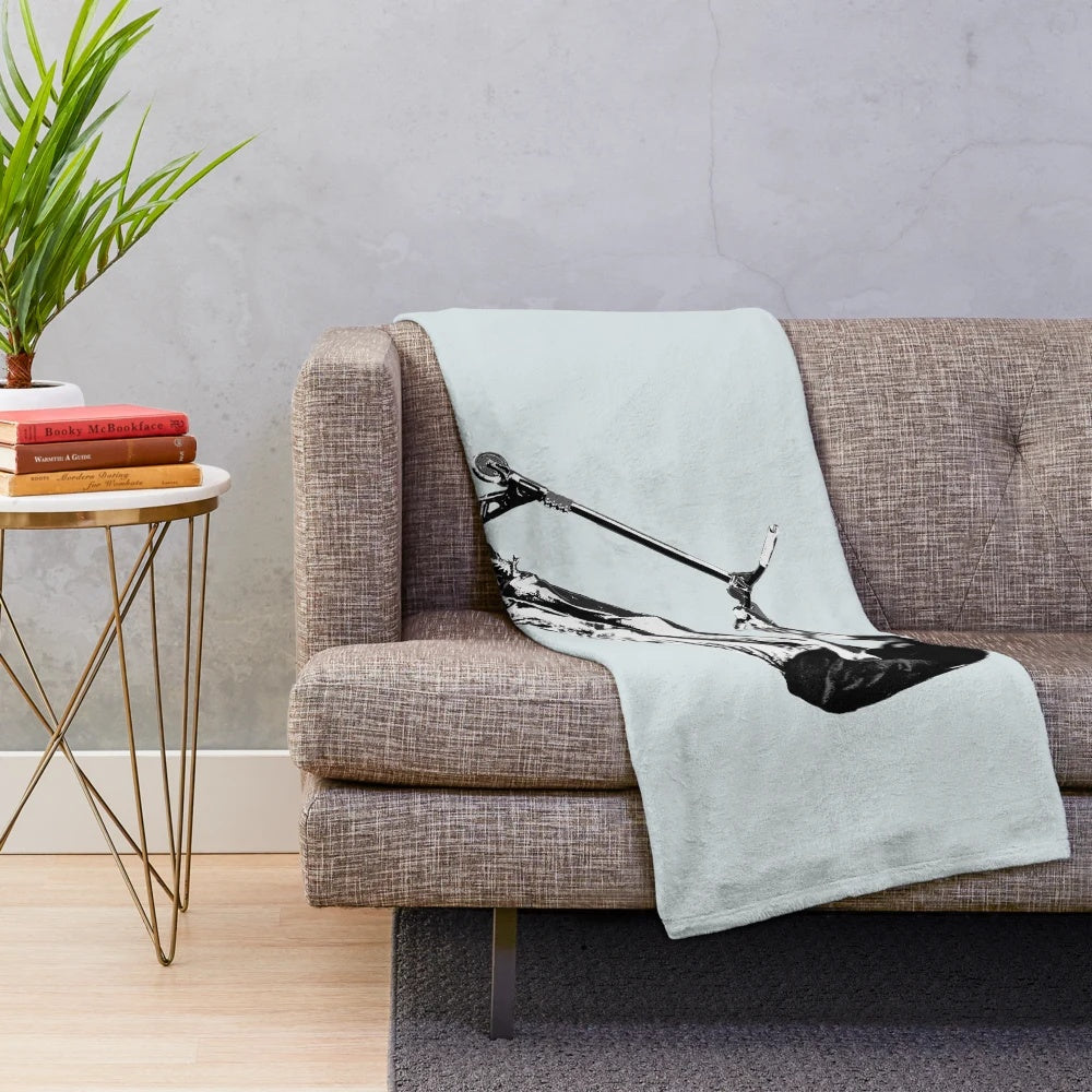 Plush blanket featuring a scooter performing a mid-air turn stunt