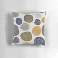 An abstract pattern of interlocking circles in navy and mustard colors on a decorative pillow.