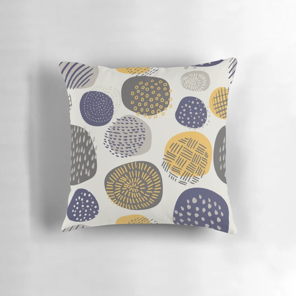 An abstract pattern of interlocking circles in navy and mustard colors on a decorative pillow.
