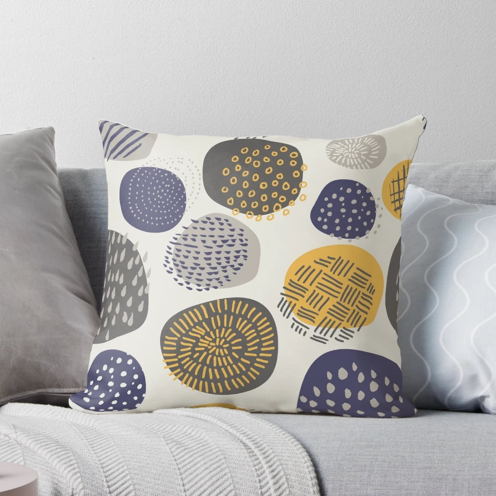 An abstract pattern of interlocking circles in navy and mustard colors on a decorative pillow.