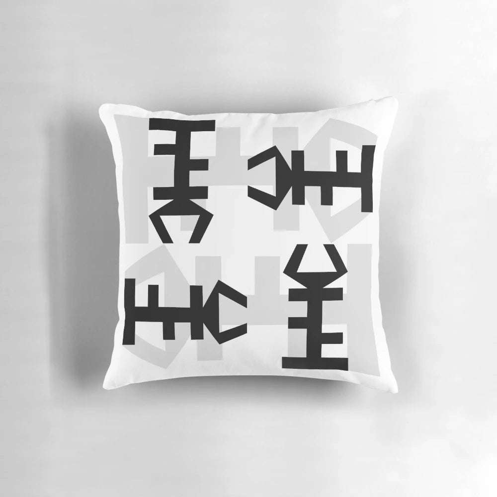 Decorative throw pillow featuring an authentic African symbol design in black and white.