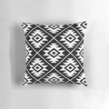 Decorative black and white Aztec tribal pattern throw pillow with geometric shapes and symbols