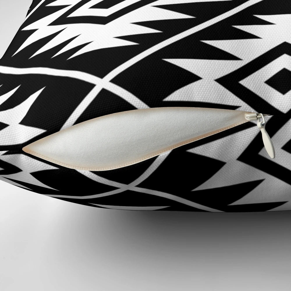 Decorative black and white Aztec tribal pattern throw pillow with geometric shapes and symbols