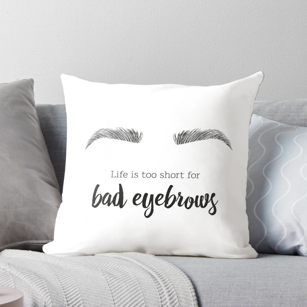 A decorative throw pillow featuring a minimalist illustration of a woman's face and stylized eyebrows.