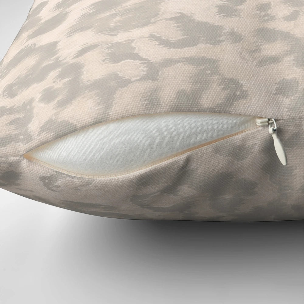Beige leopard print pillow with a modern, fashionable animal skin design