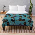 Black and tan coonhound printed on a teal plush blanket