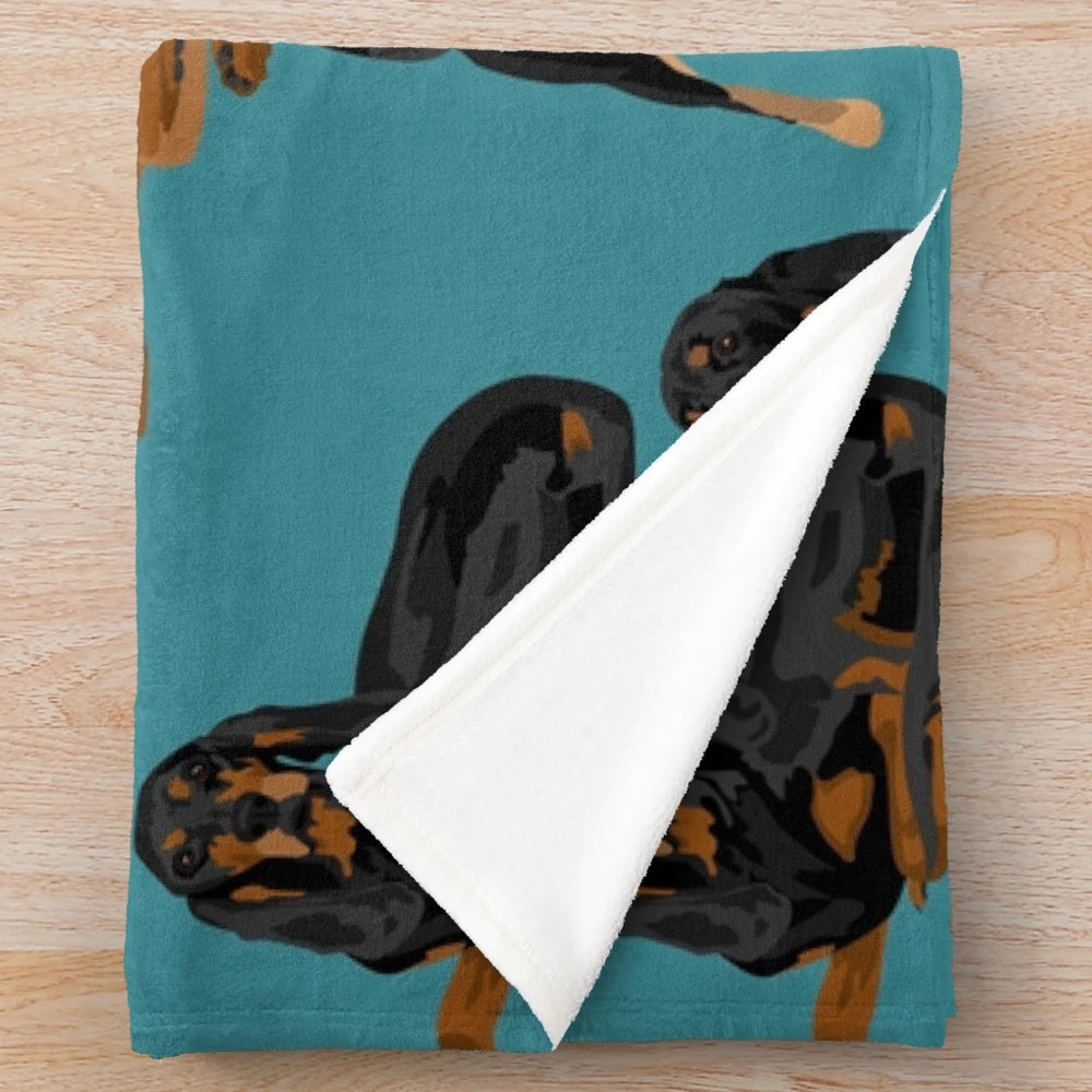 Black and tan coonhound printed on a teal plush blanket