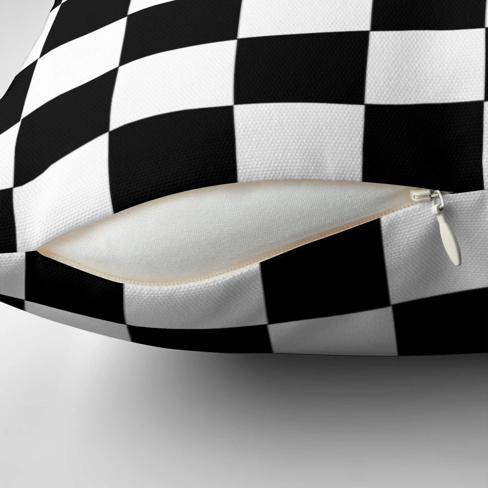 Black and white checkerboard pattern pillow with a classic grid design