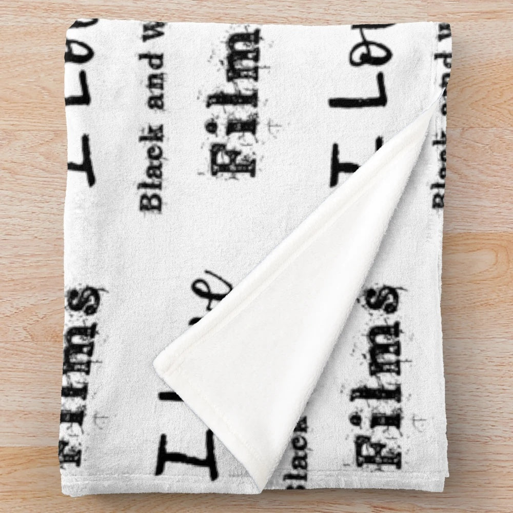 Plush blanket with black and white films illustration and quote