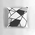 Black and white geometric pattern pillow with abstract lines and shapes