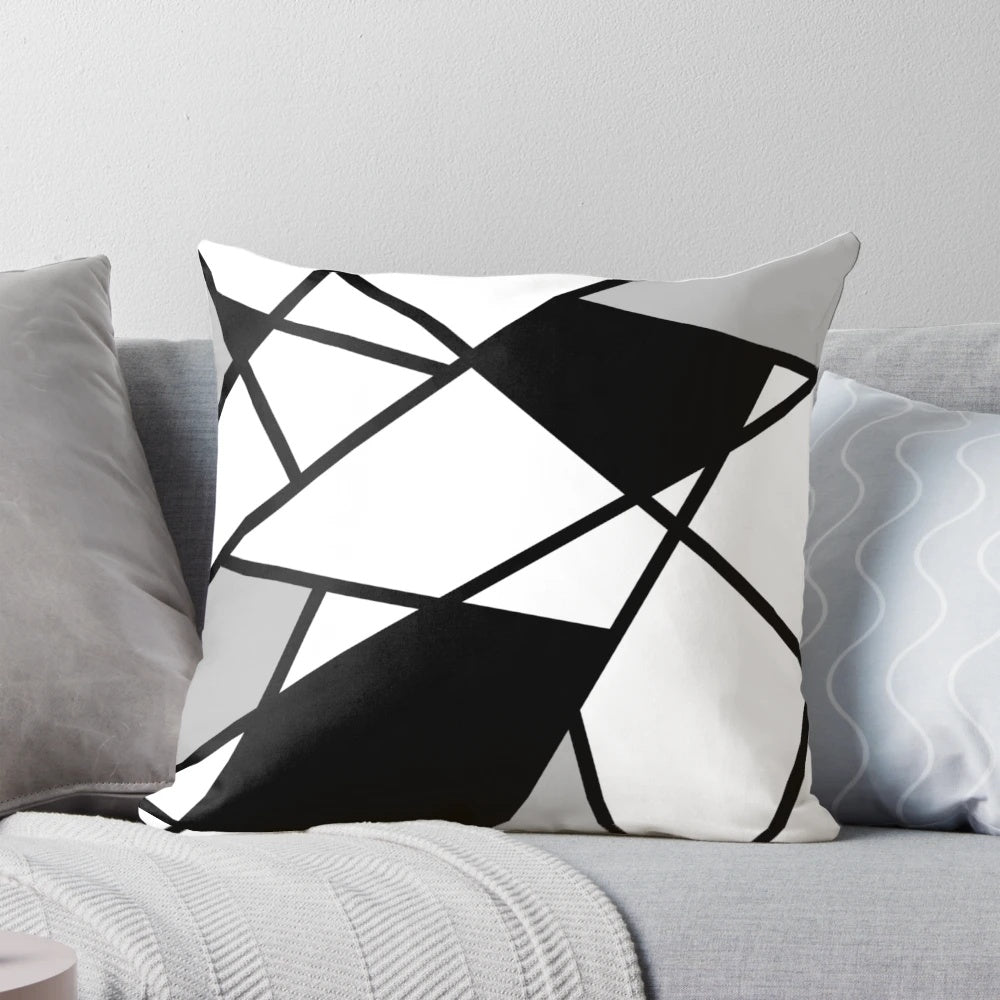 Black and white geometric pattern pillow with abstract lines and shapes