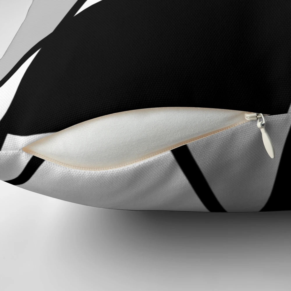 Black and white geometric pattern pillow with abstract lines and shapes