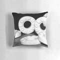 Closeup image of a pillow featuring black and white mints against a white background