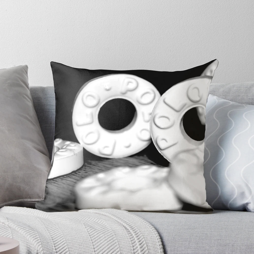 Closeup image of a pillow featuring black and white mints against a white background