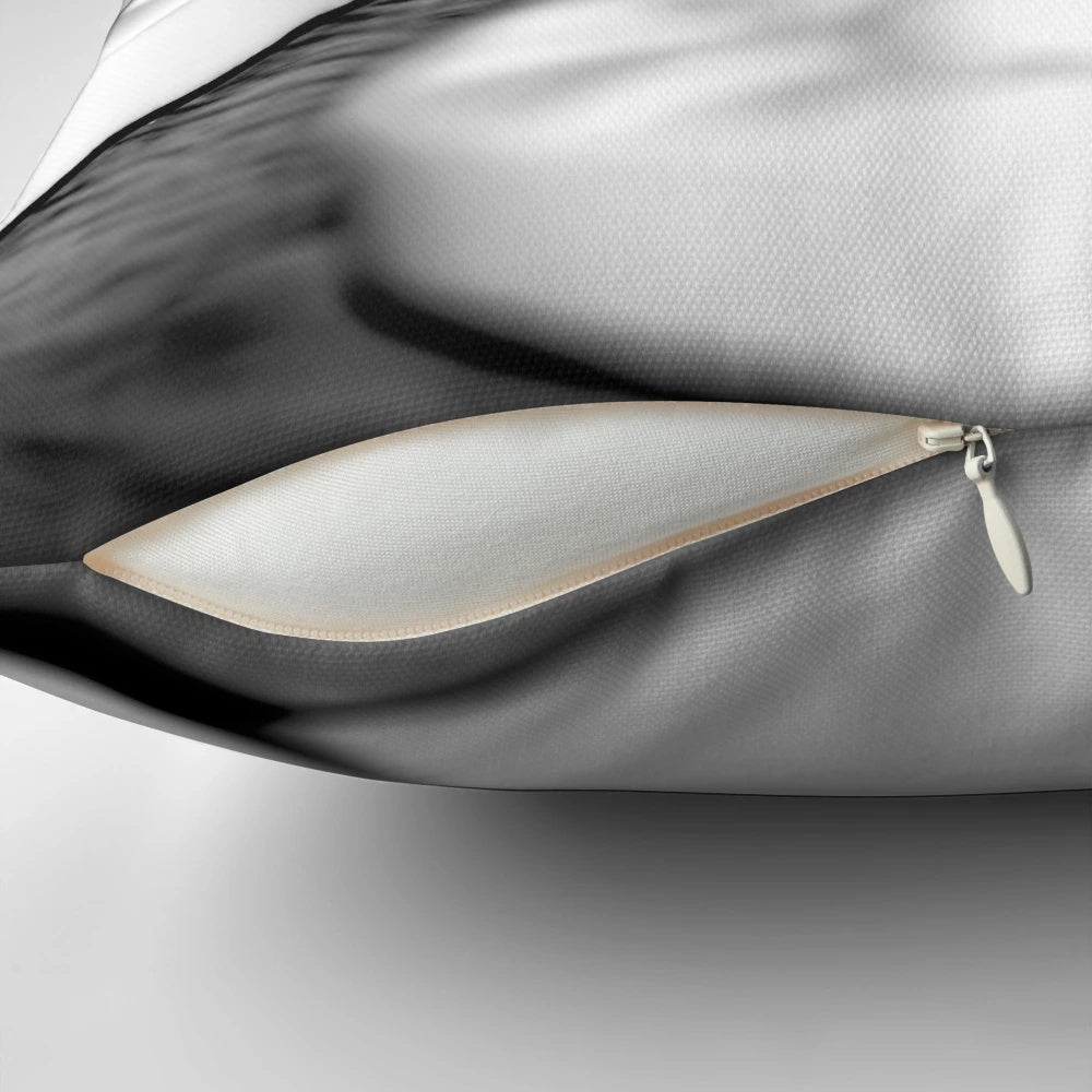Closeup image of a pillow featuring black and white mints against a white background